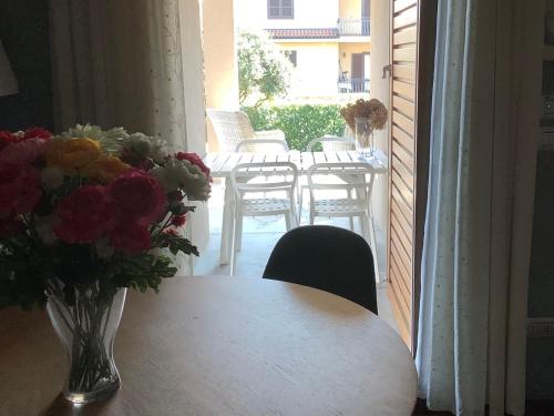 a table and chairs and a vase of flowers on a balcony at B&B La Casa di Angela in Cusago