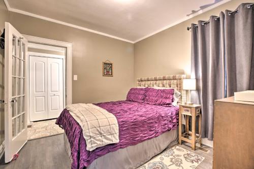 a bedroom with a purple bed and a window at Chicago Family Apartment - Kids and Pets Welcome! in Evanston