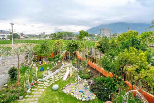 a garden with a park with a playground at 花蓮 達芙妮花園民宿 in Jian