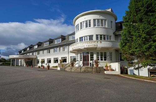 a large white building on the side of a street at Macdonald Drumossie Hotel Inverness in Inverness