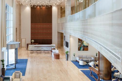 a lobby with a staircase and a waiting room at dusitD2 Salwa Doha in Doha