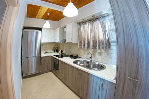 a kitchen with a sink and a refrigerator at Marabu Seaview Apartments in Nótos