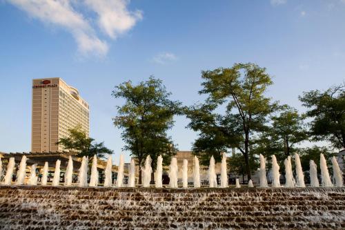 a large stone wall with trees and shrubbery at Crowne Plaza Kansas City Downtown, an IHG Hotel in Kansas City
