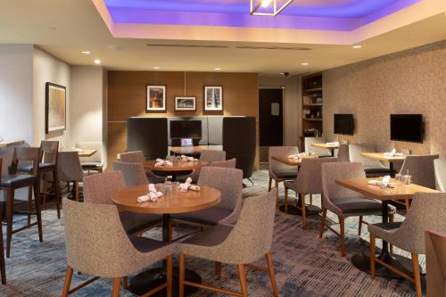 a restaurant with tables and chairs in a room at Crowne Plaza Kansas City Downtown by IHG in Kansas City