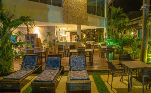 a restaurant with chairs and tables and a patio at Pousada Novo Prado in Prado
