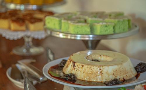 a plate of food on a table with pastries at Pousada Novo Prado in Prado