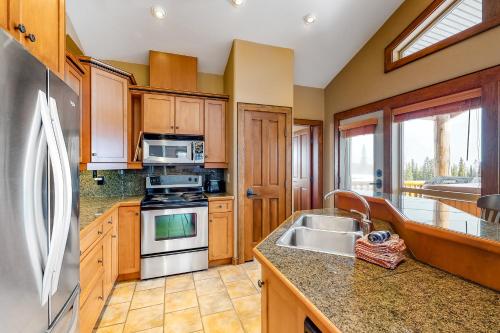 a kitchen with a sink and a stove top oven at Spyglass 4C in Big White