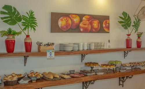 a shelf filled with lots of different types of food at Pousada Novo Prado in Prado