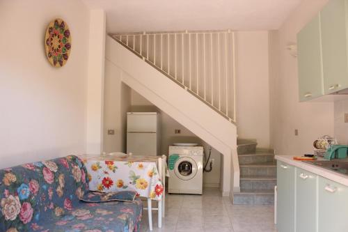a living room with a couch and a washing machine at Residenza Mediterranea in Villasimius