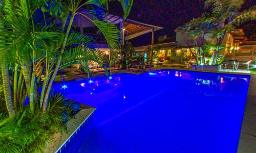 a swimming pool with blue lights in a house at Pousada Novo Prado in Prado