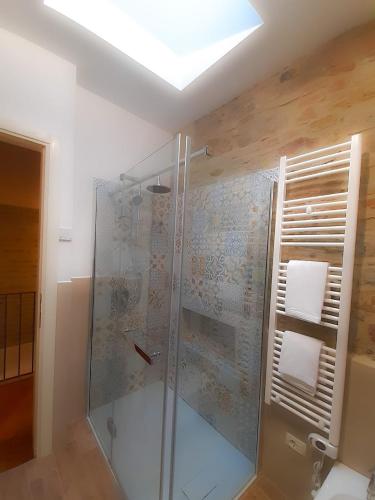 uma casa de banho com um chuveiro e uma cabina de duche em vidro. em La Casina del Porto em Fano