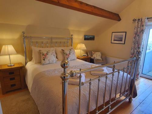 a bedroom with a bed with a metal frame at Gorse Hill Farm in Newcastle