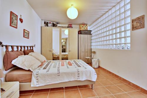 ポルト・ヴェッキオにあるAppartement T2 Prunello By Intendance Excellencyのベッドと大きな窓のある寝室