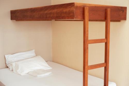 a bunk bed with a ladder on top of it at Rotta Hotel in Tangara da Serra