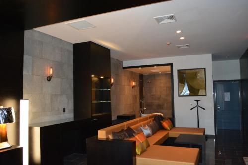 a living room with a couch and a table at The One Boutique Hotel in Queens