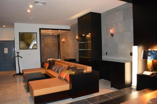a living room with a couch and a table at The One Boutique Hotel in Queens
