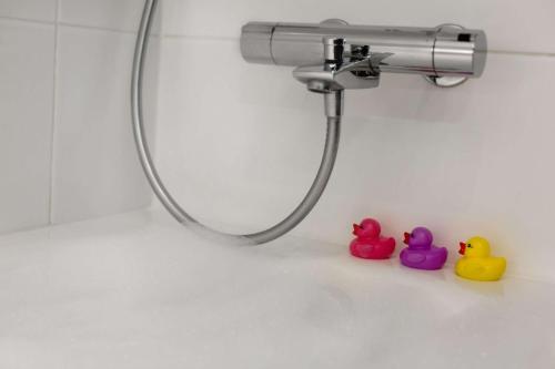 two rubber ducks sitting next to a bathroom sink at Scandic Tampere Station in Tampere