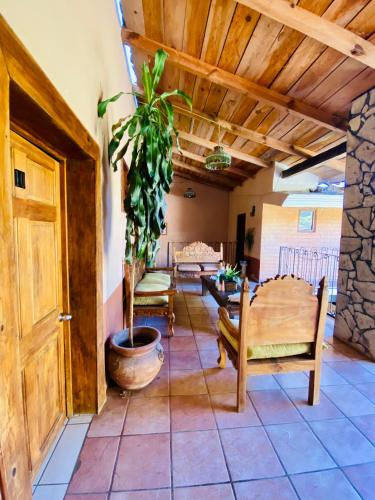 a living room with a wooden door and a potted plant at Hotel De Cervantes in San Sebastián