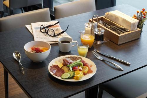 a table with a plate of breakfast food on it at Scandic Havet in Bodø