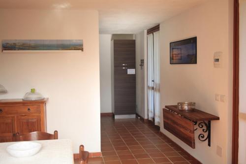 um quarto com um corredor com uma mesa e uma porta em B&B Sa Serra em Stintino