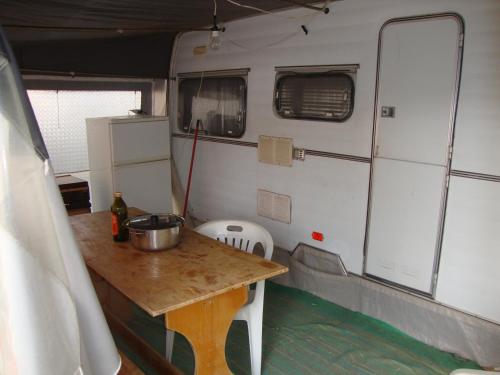a table in an rv with a bucket on it at Camping Tellina in Manfredonia