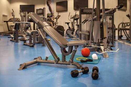 a gym with several exercise equipment on a blue floor at Scandic Hafjell in Hafjell