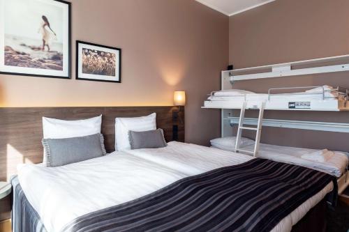 a bedroom with a large bed with two bunk beds at Scandic Helsinki Airport in Vantaa