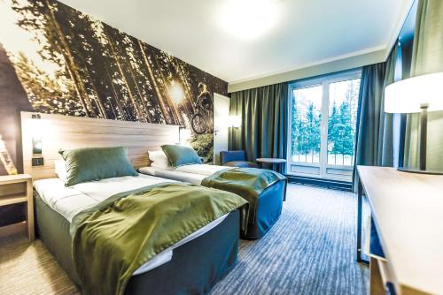 a hotel room with two beds and a window at Scandic Lillehammer Hotel in Lillehammer