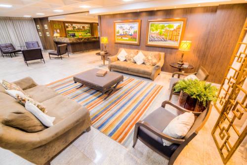 - un grand salon avec des canapés et des chaises dans l'établissement Hotel Dan Inn Uberaba & Convenções By Nacional Inn, à Uberaba