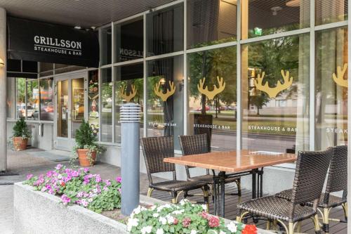 a table and chairs in front of a store at Scandic Tampere Hämeenpuisto in Tampere