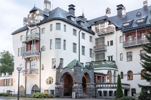 a large white building with a gray roof at Scandic Imatran Valtionhotelli in Imatra