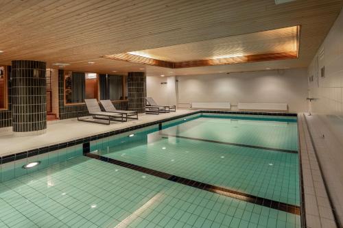 a large swimming pool in a building at Scandic Jyväskylä City in Jyväskylä