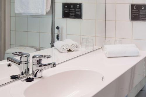 a bathroom with a sink and a mirror at Scandic Polar in Rovaniemi