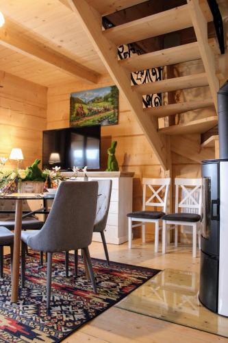 a dining room with a table and a television at Domki w Białce pod Basenami, 50 m od term i wyciągów in Białka Tatrzanska