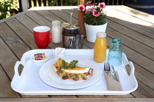 a tray with a plate of food on a table at Havelock North Motor Lodge in Havelock North