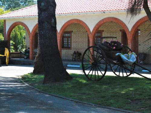 a horse drawn carriage parked in front of a building at Belvilla by OYO Hacienda Lugar de Sinde in Val