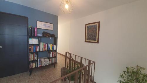 a room with a staircase with a book shelf with books at Base Camp México in Orizaba