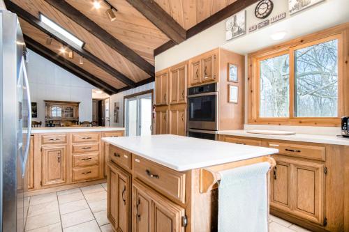 a large kitchen with wooden cabinets and white counter tops at Harbor Country Family Lodge in Union Pier