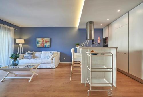 a kitchen and living room with a couch and a table at Solar do Monte in Estoril