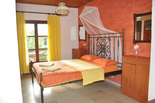 a bedroom with a bed and a mirror and a window at Kahlua in Liapades