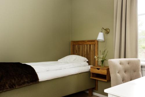 מיטה או מיטות בחדר ב-Hotel Kallgården