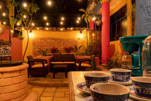 a room with a table with dishes on it with lights at Hotel Tepeyac in San Cristóbal de Las Casas