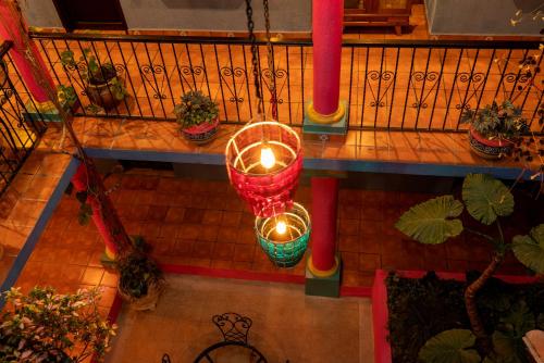an overhead view of candles on a balcony with plants at Hotel Tepeyac in San Cristóbal de Las Casas