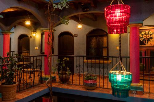 a building with a balcony with red and green lights at Hotel Tepeyac in San Cristóbal de Las Casas