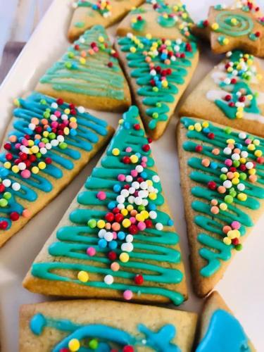 a row of decorated gingerbread cookies with colorful sprinkles at Hotel Milanese in Rimini