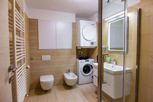 a bathroom with a washing machine and a washer at Apartment Stinjan, Istria 2 in Štinjan