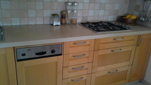 a kitchen with a stove and a counter top at Kfar Saba View Apartment in Kefar Sava