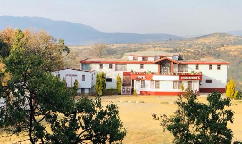 a large white building in the middle of a field at Hotel Fernando´s in Tlalpujahua de Rayón