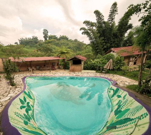 a large swimming pool in front of a house at Cabañas Los Achicuales in Cuetzalán del Progreso