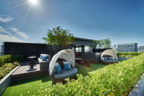 a rooftop garden with two domes and chairs on a building at The Gate Hotel Ryogoku by Hulic in Tokyo